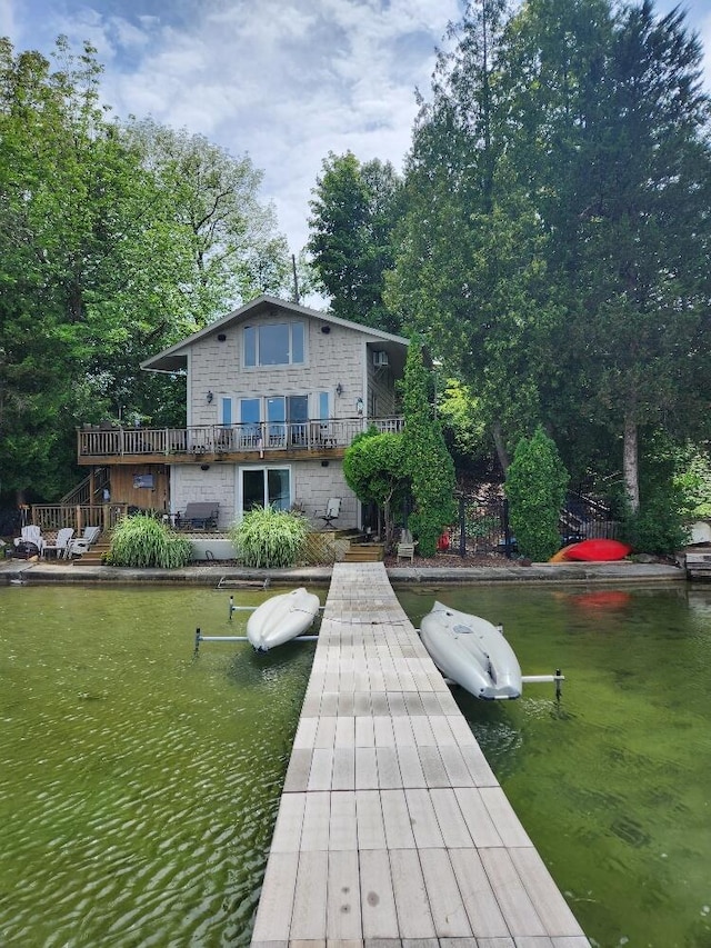 dock area featuring a deck with water view