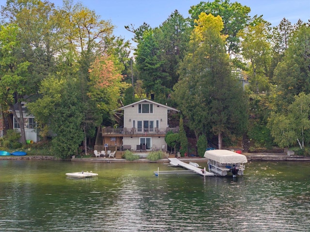 dock area featuring a deck with water view and boat lift