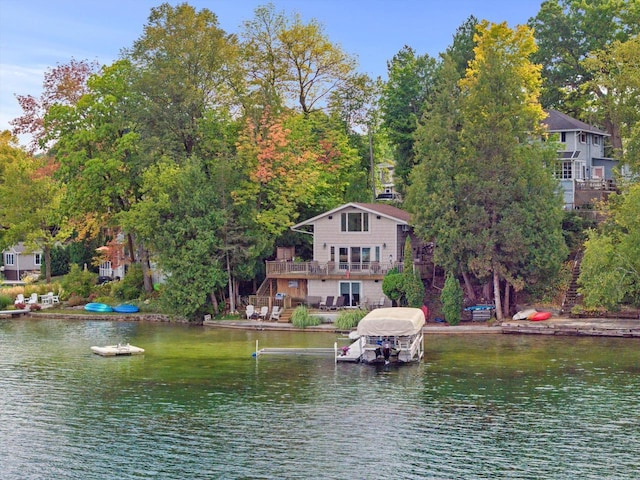 property view of water featuring stairway and a dock