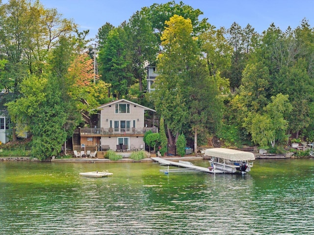 exterior space with a balcony and a deck with water view