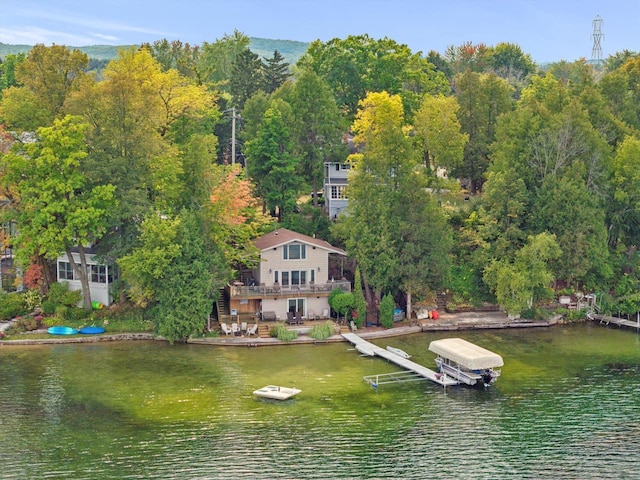 dock area with boat lift and a water view