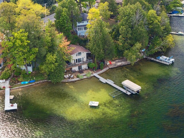 view of yard with a deck with water view and a fire pit