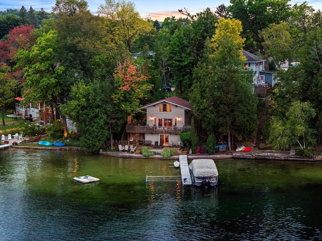 exterior space featuring boat lift and a deck with water view