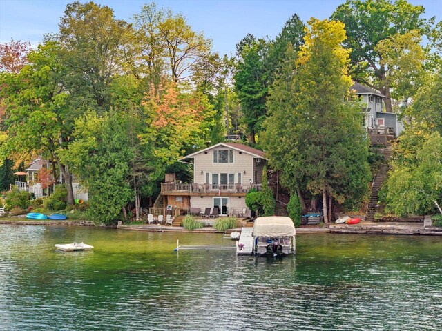 wooden terrace with a water view and a grill