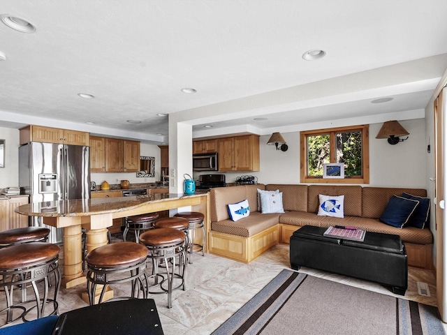 living area with recessed lighting and marble finish floor