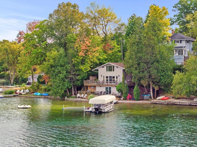 exterior space featuring a deck with water view