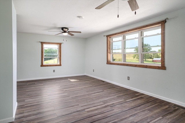 unfurnished room featuring a textured ceiling, dark wood-type flooring, and ceiling fan