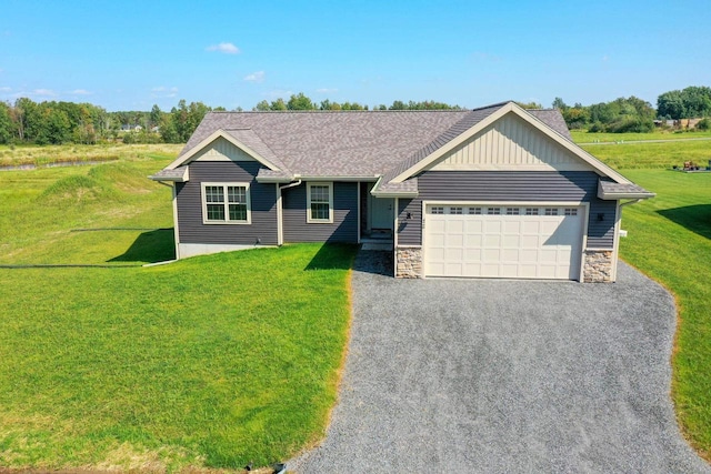 view of front of house with a garage and a front lawn