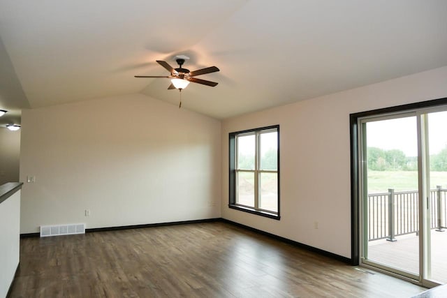 spare room with lofted ceiling, ceiling fan, and dark wood-type flooring