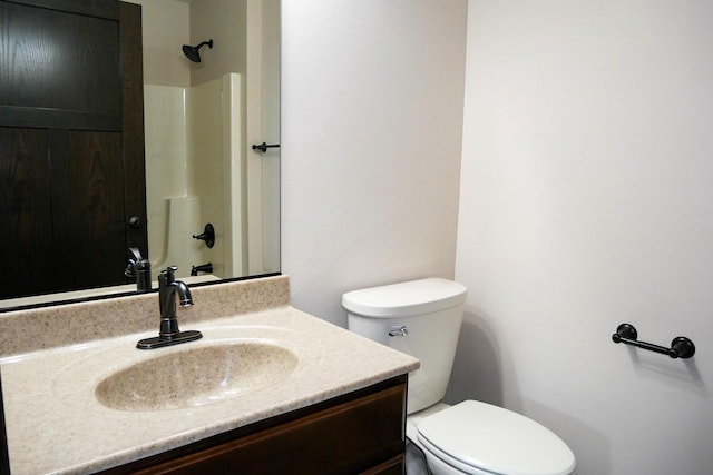 bathroom featuring a shower, vanity, and toilet