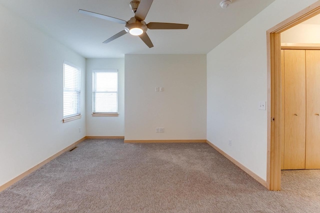 interior space with light carpet and ceiling fan