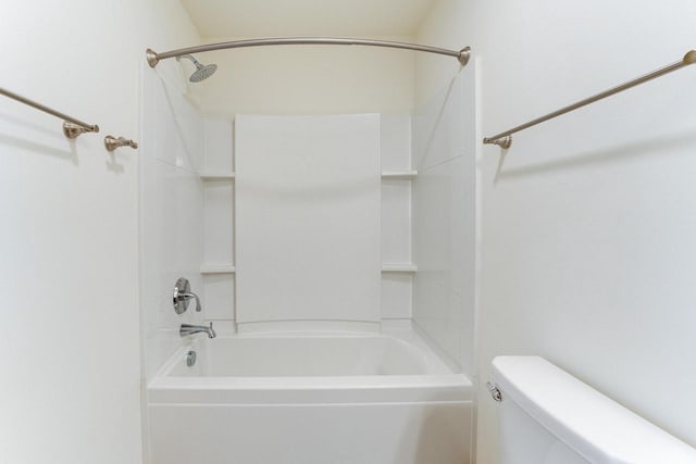 bathroom with toilet and  shower combination