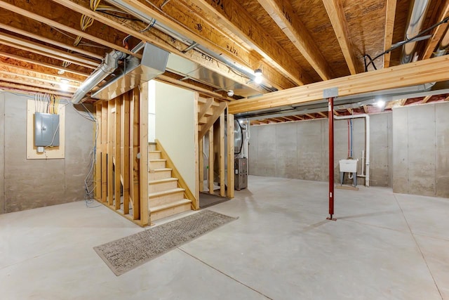 basement featuring electric panel and sink