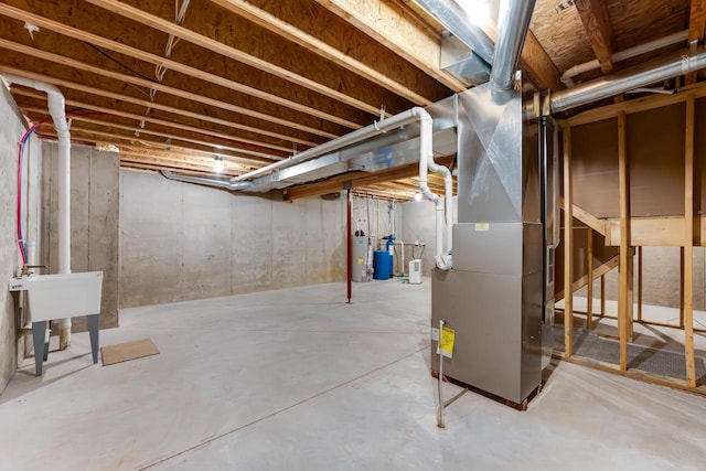 basement with water heater and heating unit