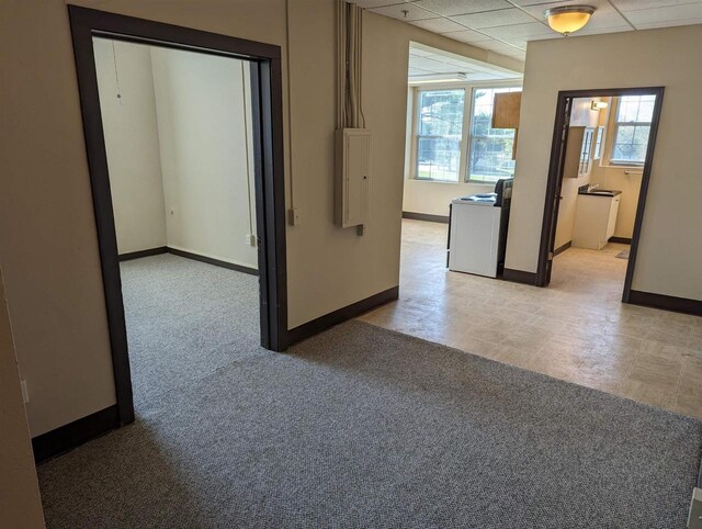 unfurnished room featuring a paneled ceiling and electric panel