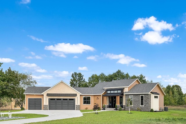 view of front of property with a front yard and a garage