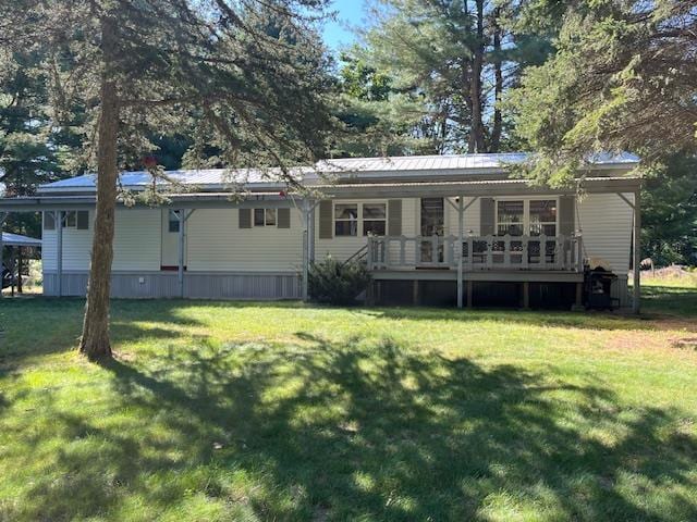 back of house with a lawn and a wooden deck