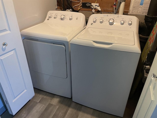 washroom featuring separate washer and dryer and dark hardwood / wood-style floors