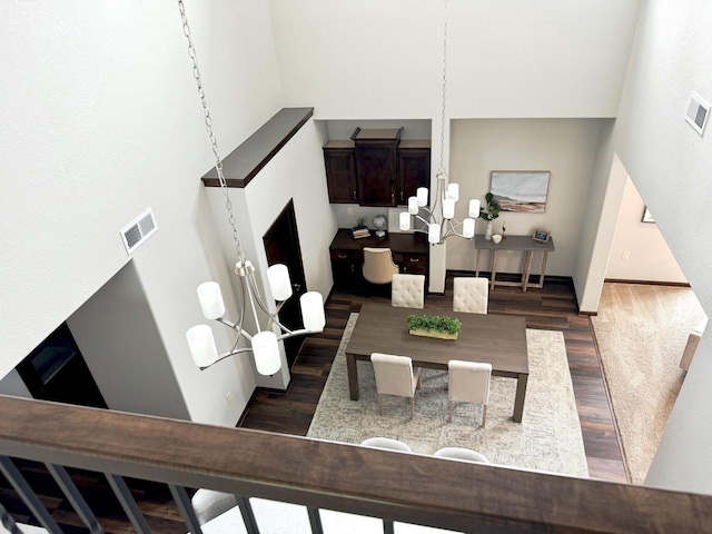 living room featuring a notable chandelier and dark hardwood / wood-style floors