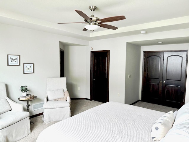 carpeted bedroom featuring a closet and ceiling fan