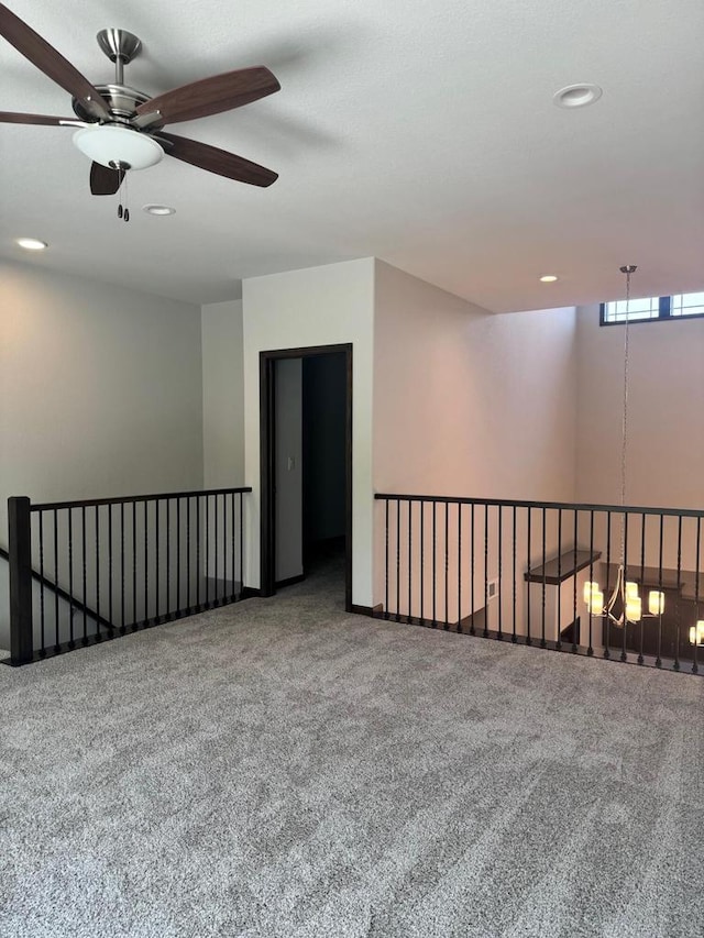 spare room featuring ceiling fan and carpet floors