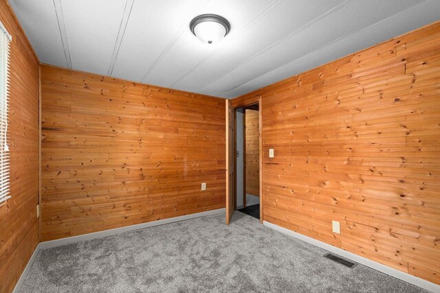 N1802 Shambeau, Waupaca, WI 54981 - empty room with visible vents, baseboards, carpet, and wood walls
