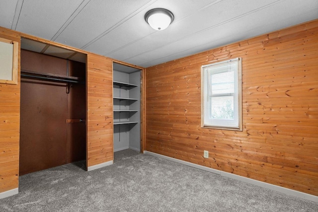 N1802 Shambeau, Waupaca, WI 54981 - unfurnished bedroom featuring wooden walls, carpet flooring, and a closet