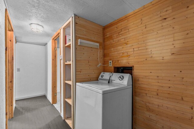 N1802 Shambeau, Waupaca, WI 54981 - laundry room with a textured ceiling, wood finished floors, wooden walls, washer / dryer, and laundry area