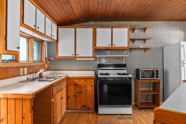 N1802 Shambeau, Waupaca, WI 54981 - kitchen featuring a sink, open shelves, stainless steel microwave, gas range oven, and freestanding refrigerator