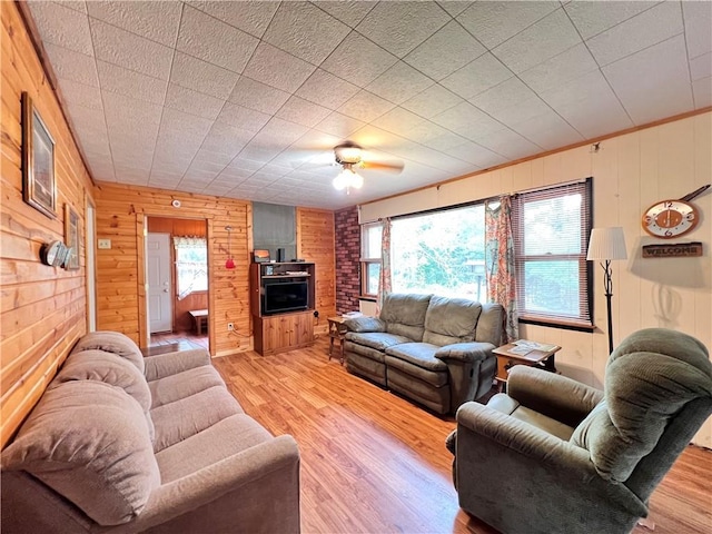 living room featuring a healthy amount of sunlight, ceiling fan, and light wood-type flooring