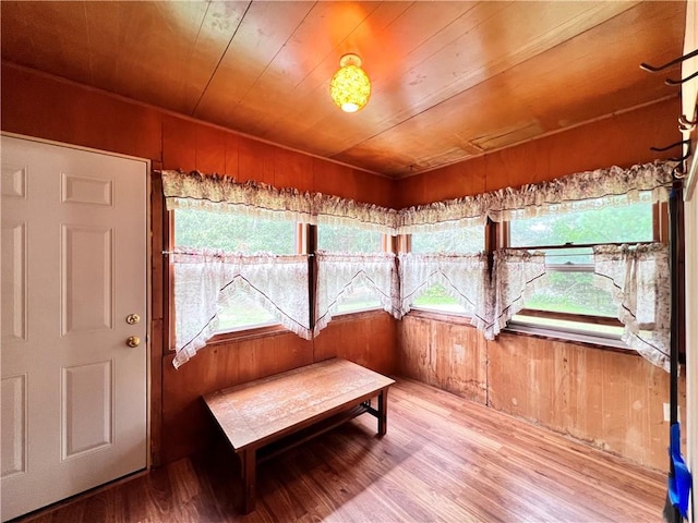 sunroom featuring wood ceiling and a healthy amount of sunlight