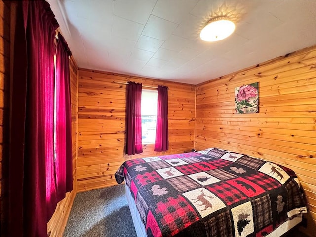 carpeted bedroom featuring wood walls