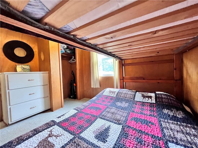 bedroom featuring wood walls and carpet