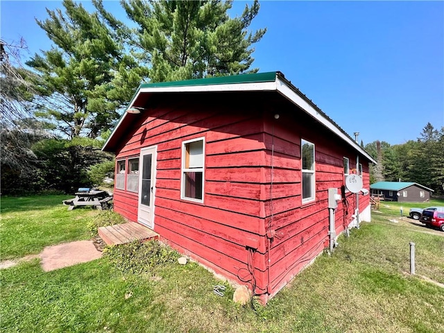 view of outbuilding with a yard