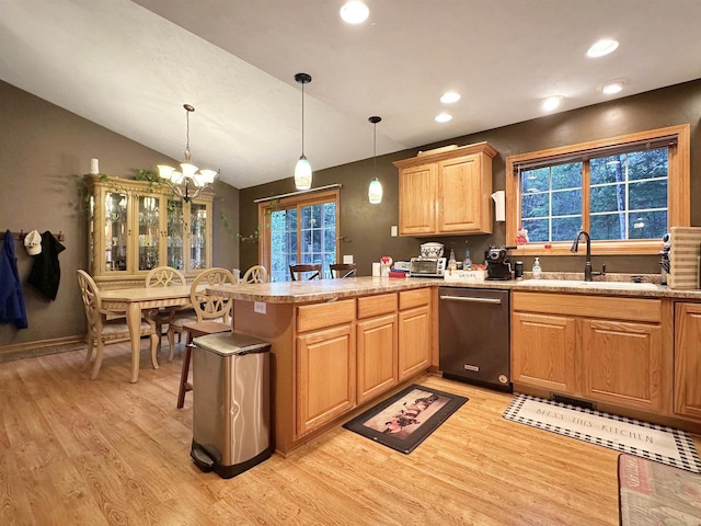 kitchen featuring stainless steel dishwasher, kitchen peninsula, a notable chandelier, and light wood-type flooring