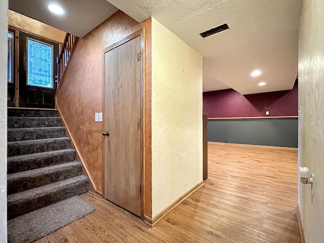 hallway with wood-type flooring