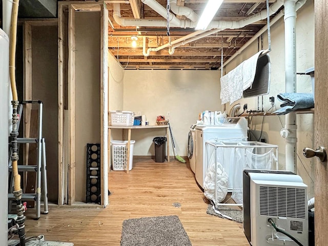 basement featuring hardwood / wood-style floors and separate washer and dryer