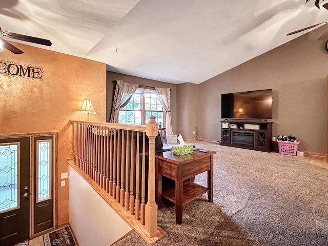 living room featuring lofted ceiling, ceiling fan, and carpet floors