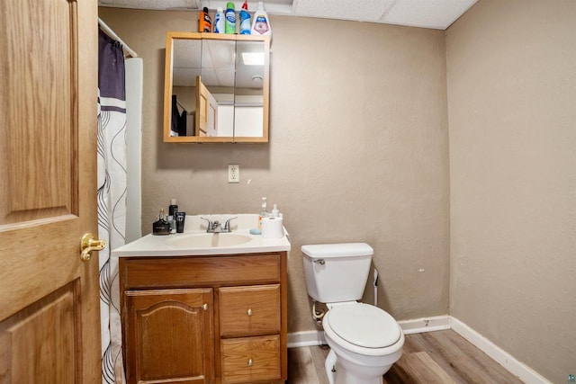 bathroom with wood-type flooring, toilet, and vanity