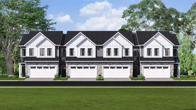 view of front of home featuring stone siding, board and batten siding, and a garage