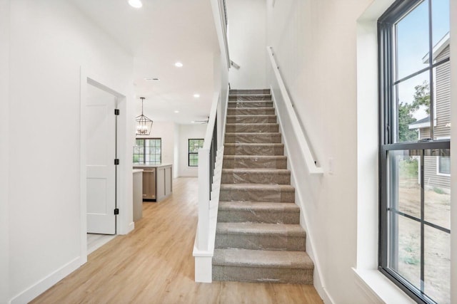 stairway featuring recessed lighting, baseboards, and wood finished floors