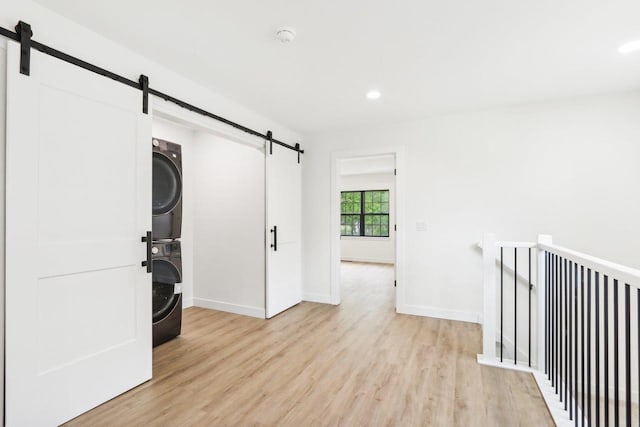 317 Maple St, Pardeeville, WI 53954 - hall featuring a barn door, stacked washer / drying machine, light wood finished floors, baseboards, and recessed lighting