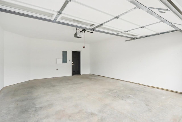 317 Maple St, Pardeeville, WI 53954 - garage featuring electric panel and a garage door opener