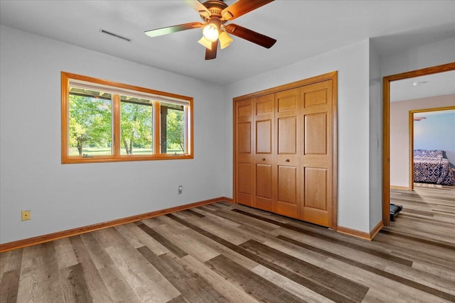 unfurnished bedroom featuring baseboards, visible vents, and light wood-type flooring