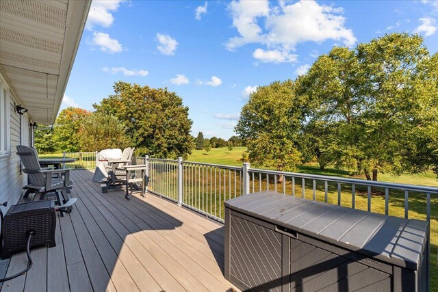 wooden terrace featuring a yard