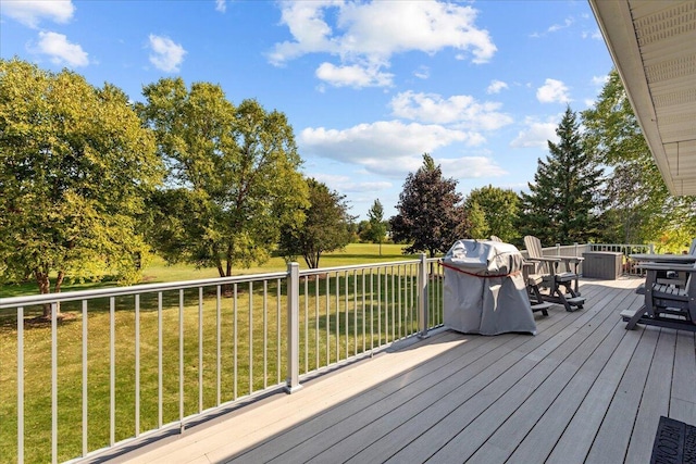 wooden deck with a lawn