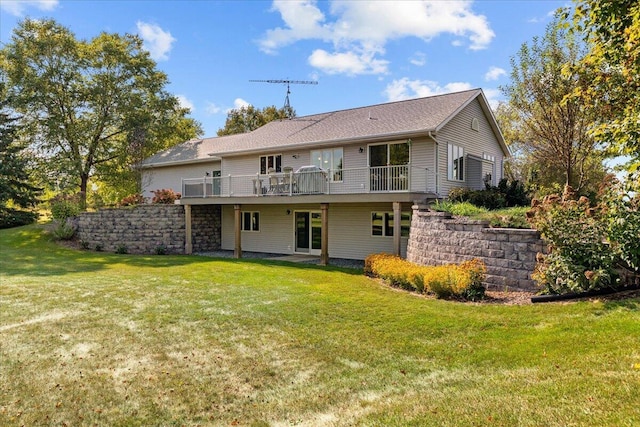 rear view of house featuring a yard and a deck