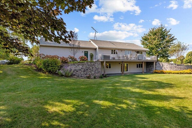 back of property featuring a lawn and a deck