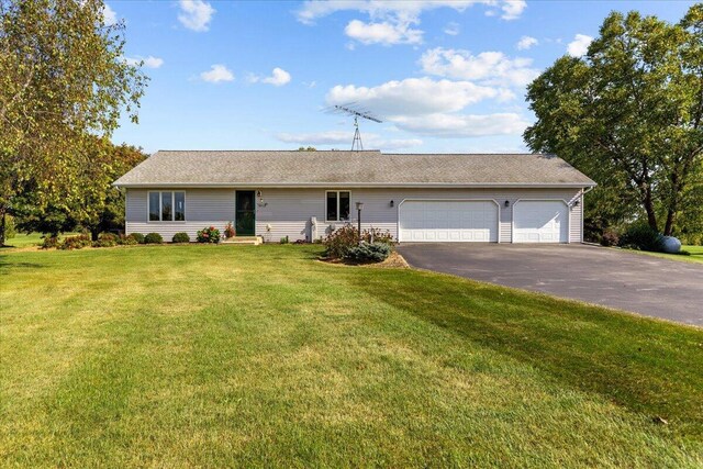 ranch-style house with a front yard, an attached garage, and driveway