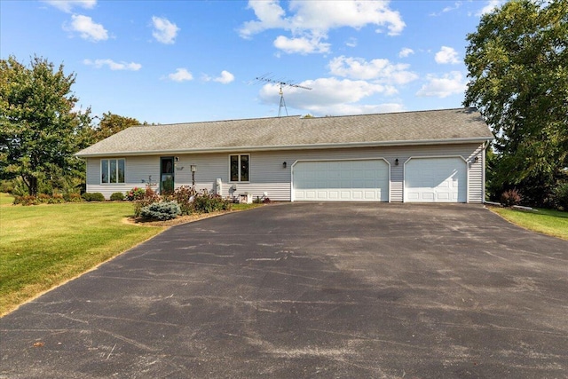 ranch-style house with a garage, driveway, and a front yard